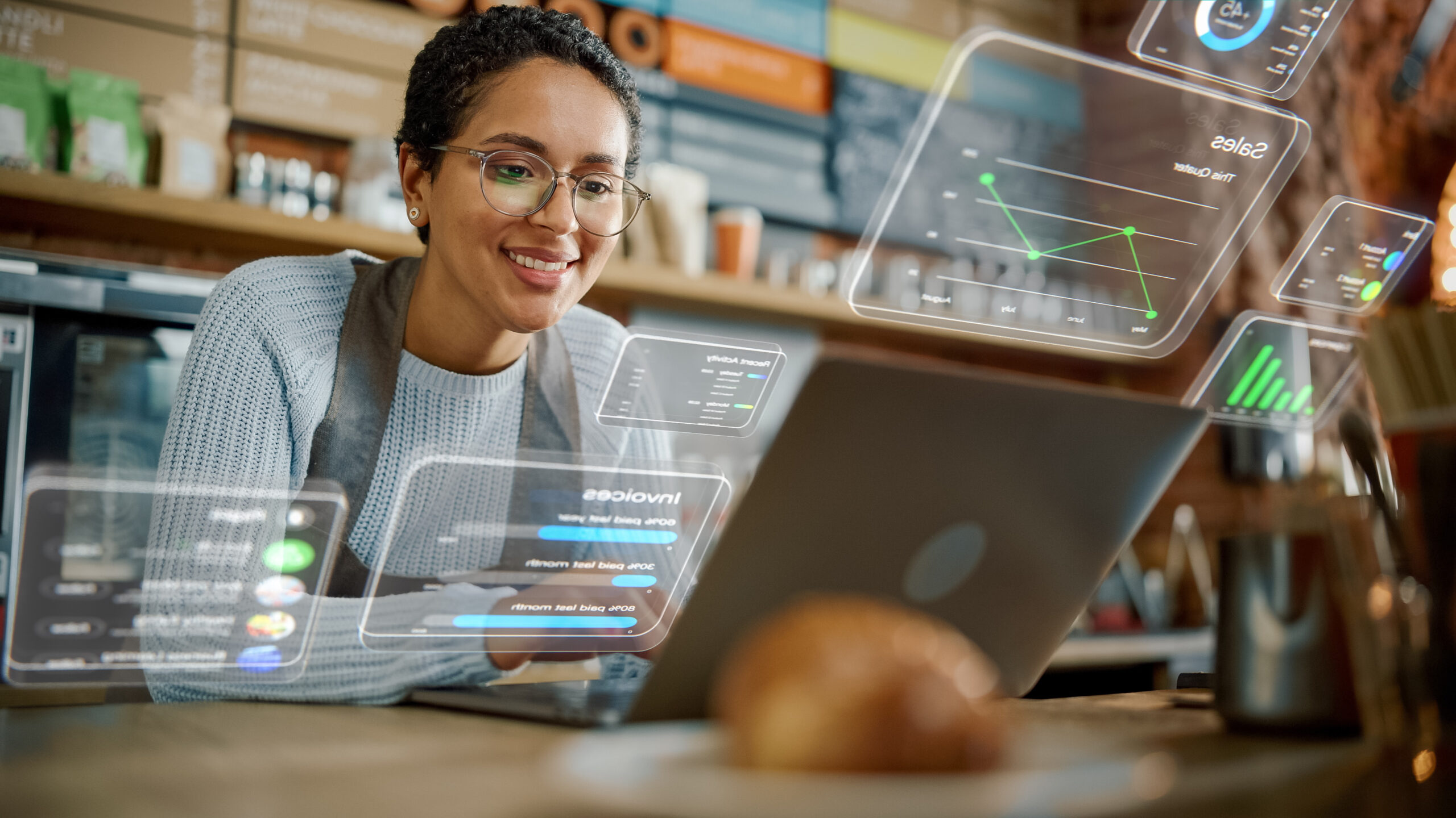 Woman working on a computer with technical screens